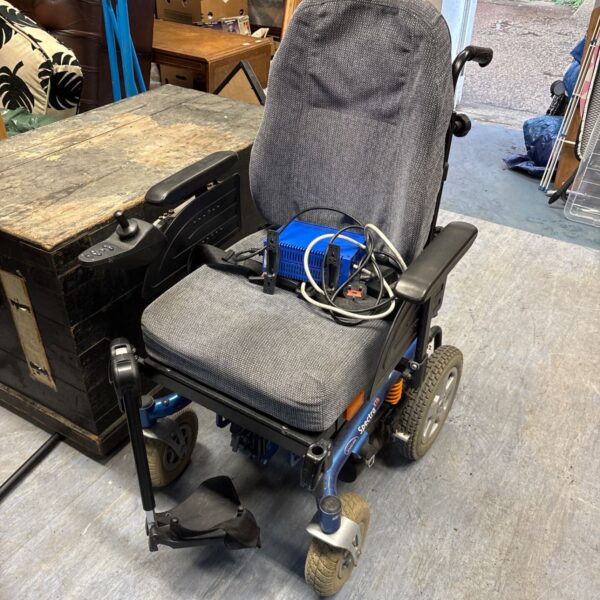 Invacare Spectra XTR power wheelchair with a blue frame and padded seat.