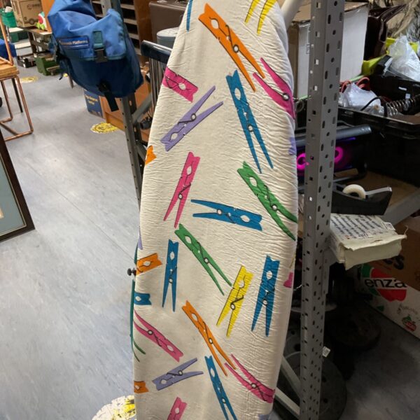 Colorful ironing board with a playful clothespin pattern for laundry.