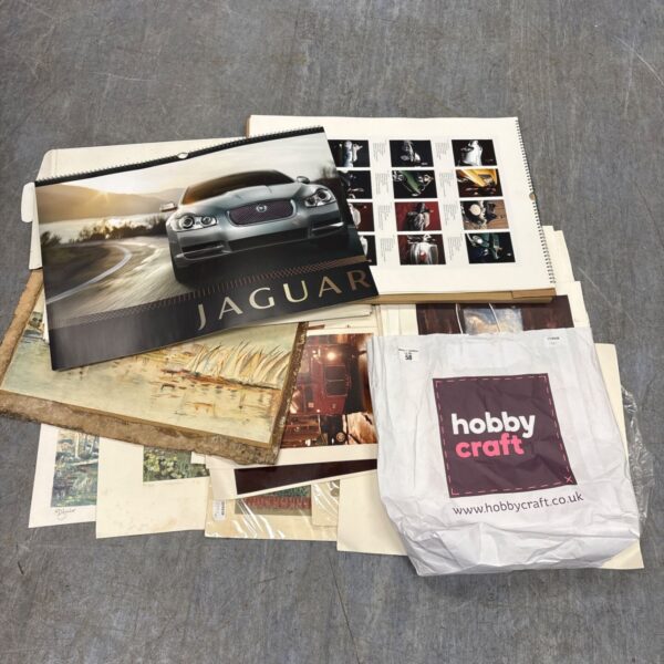 Mixed art collection featuring a Jaguar print and vintage ephemera.