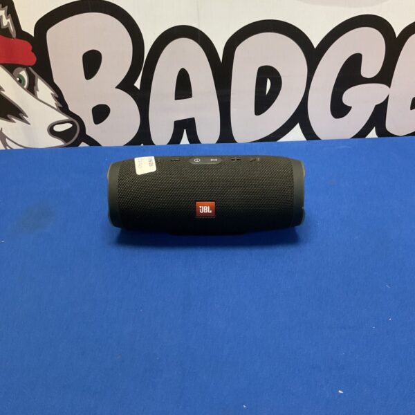 Black JBL Charge 3 portable Bluetooth speaker on a patterned surface.