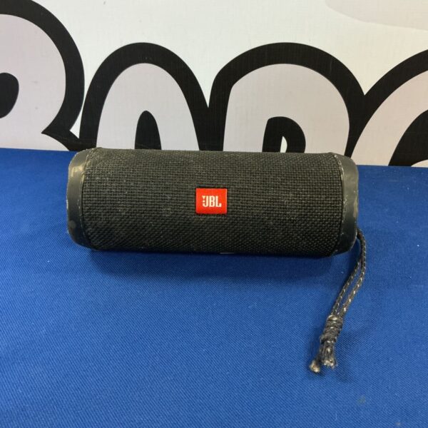 Black JBL Flip 4 portable Bluetooth speaker, side view.