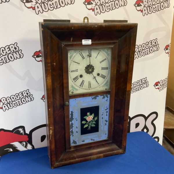 Antique Jerome & Co wall clock with glass front and painted details.