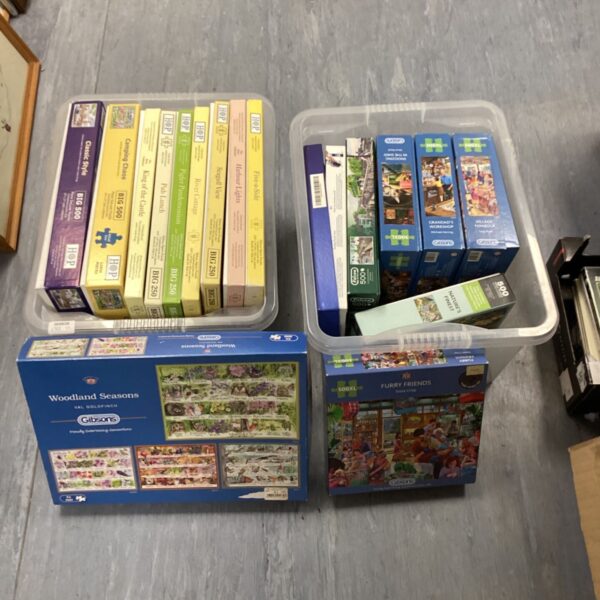 Two boxes of vintage 500-piece jigsaw puzzles with scenic imagery.