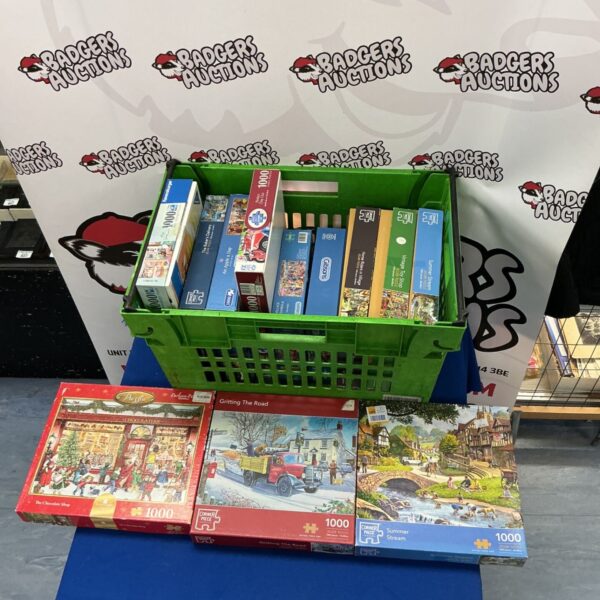 Crate filled with a lot of jigsaw puzzles from various brands.