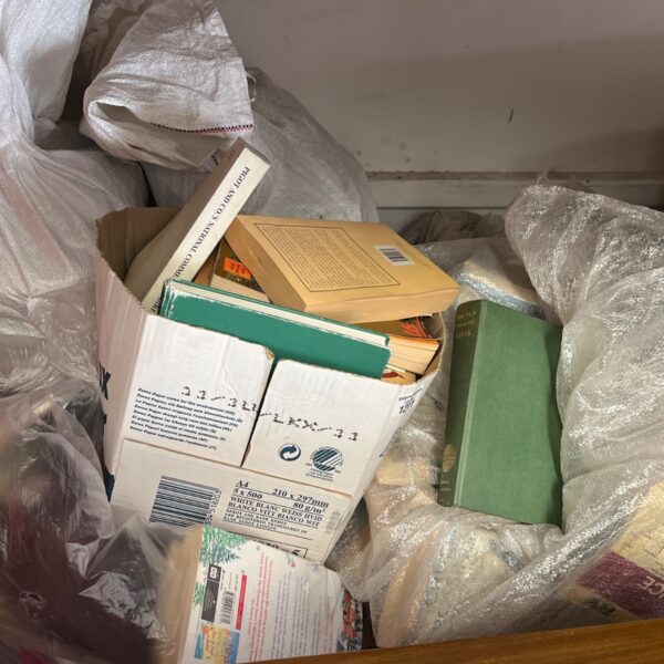 Mixed job lot of vintage and collectable books on a surface.
