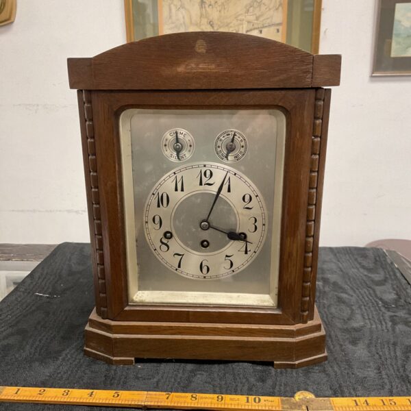 Vintage Junghans mantel clock with silvered dial and wooden case.