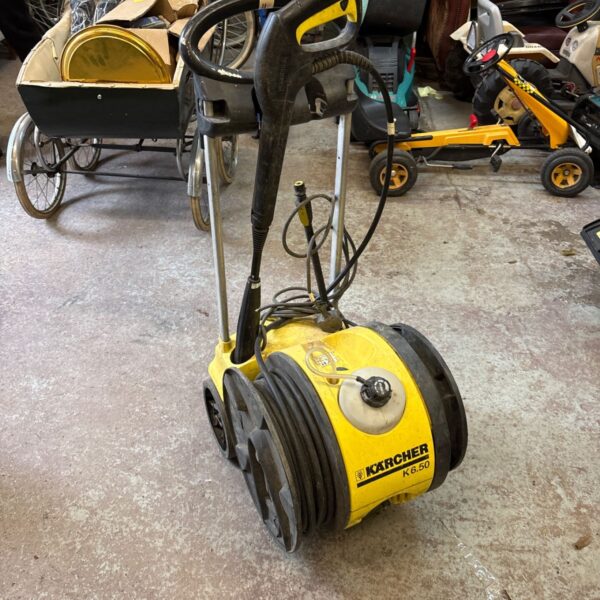 Yellow Karcher K6.50 pressure washer with hose and handle.