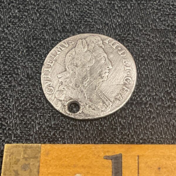 Silver shilling of King William III with bust and inscription.