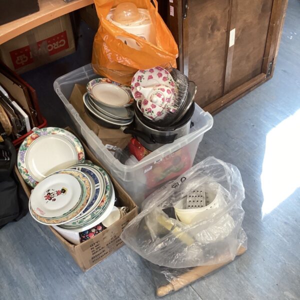 Assorted kitchenware bundle including plates and pans.