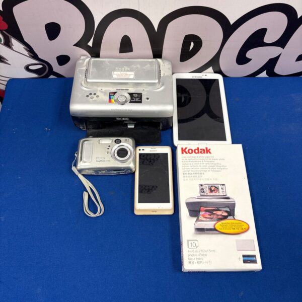 Kodak printer dock with digital camera, vintage photo printing technology.