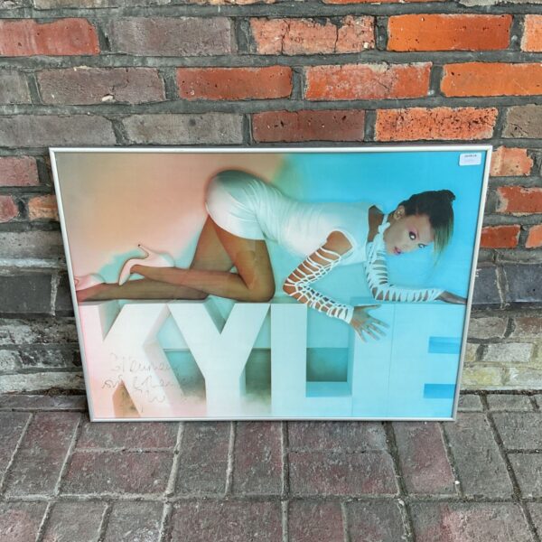 Signed Kylie Minogue poster, a vibrant pop music collectable.