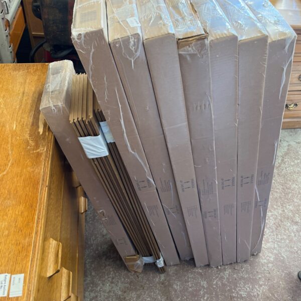 Stack of nine unopened packs of laminate flooring.