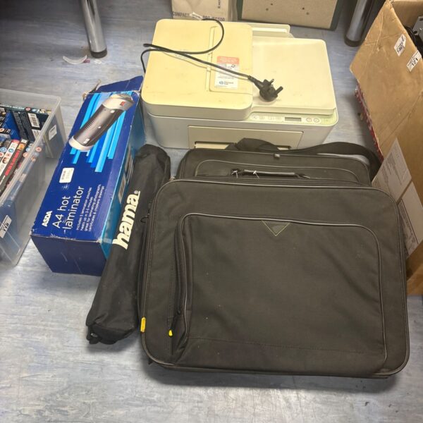 Mixed lot of tech accessories including laptop cases and a tripod.