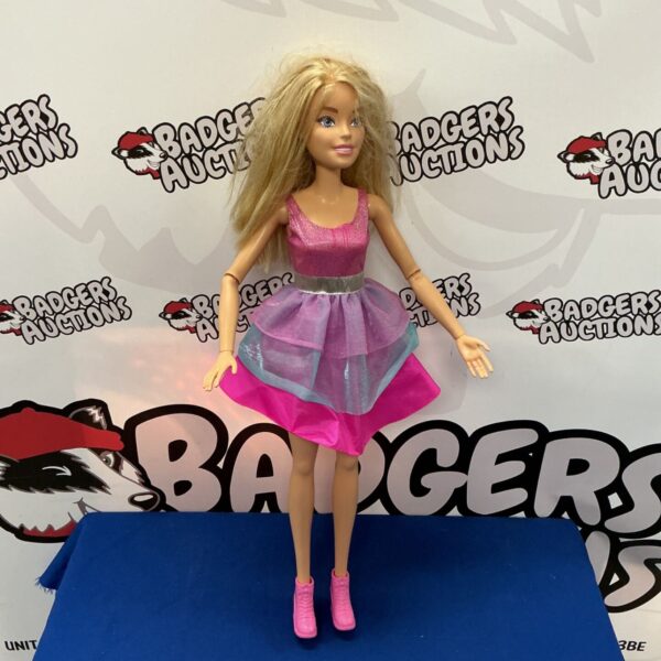 Large Barbie doll in pink gown, a collectible fashion doll.