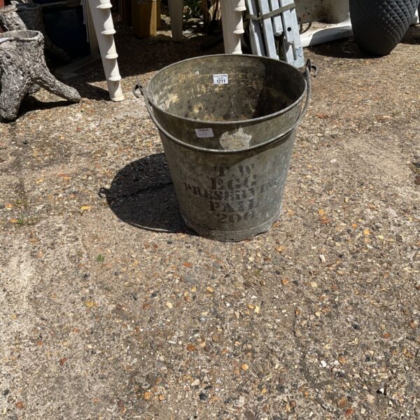 Large galvanised bucket with weathered patina, ideal for garden use.