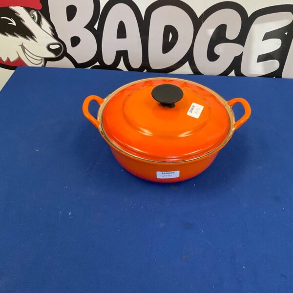 Vibrant orange Le Creuset no24 casserole pot, classic French cookware.