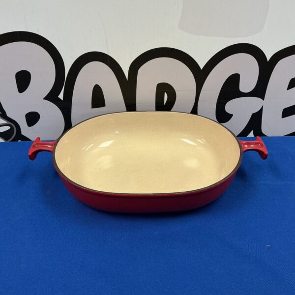 Red Le Creuset casserole dish with enamel finish.