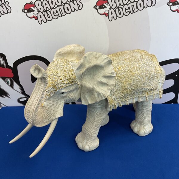 Large cream serene elephant sculpture by Leonardo with gold detailing.