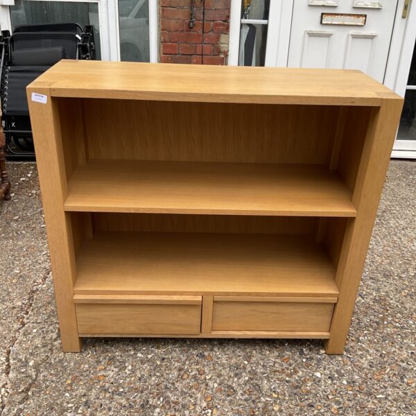 Modern light oak bookcase with two drawers for home storage.