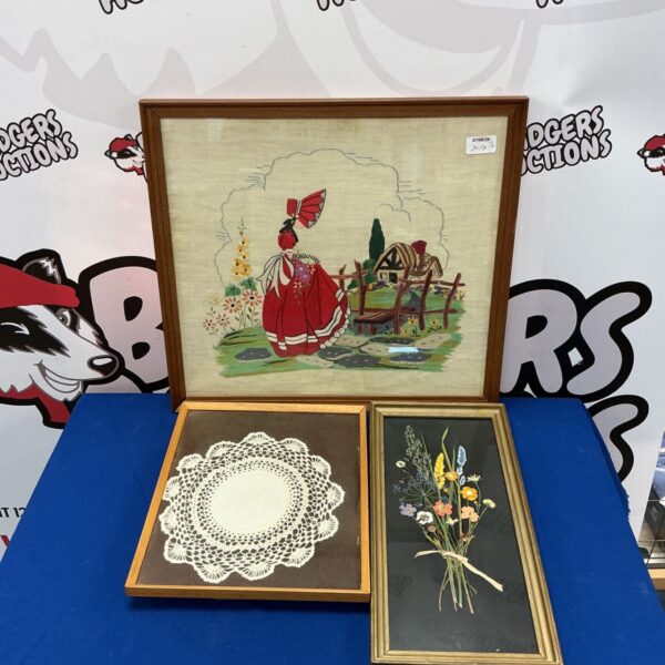 Vintage Little Red Riding Hood embroidery with dried flowers in a frame.