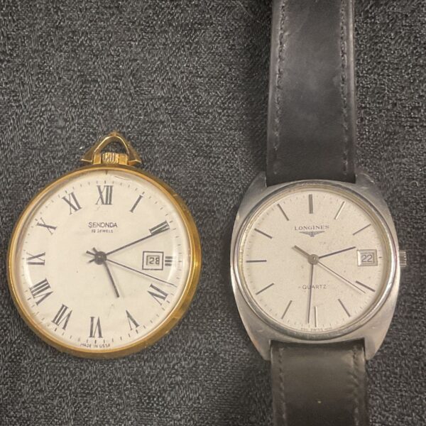 Vintage Longines quartz wristwatch with black leather strap.