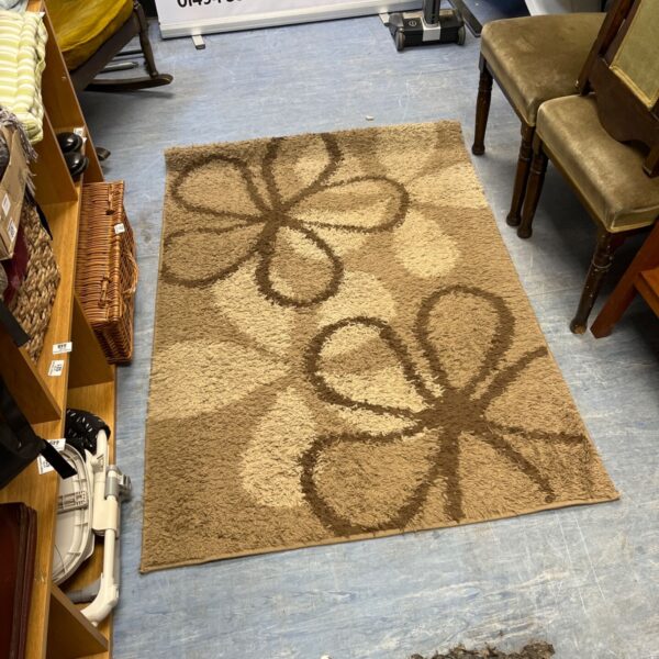 brown floral tufted area rug features a modern abstract flower pattern in neutral beige tones