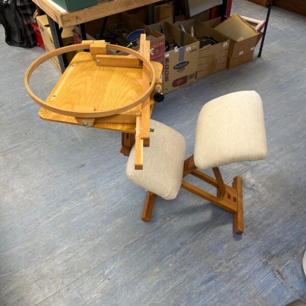 Danish-style ergonomic kneeling chair features light wood construction and a detachable wooden desk surface and embroidery hoop stand