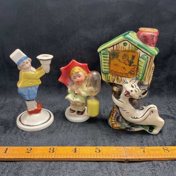 three porcelain figures inc holographic cat
