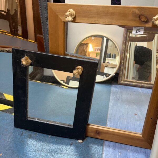 black wooden framed mirror features rustic rope detailing at the top