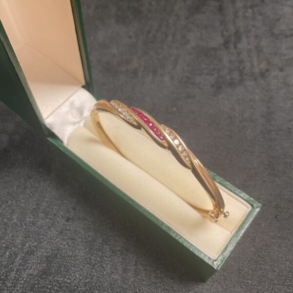 Hallmarked .375 Gold Hinged Bracelet set with two rows of seven diamonds either side of a row of seven rubies 13g