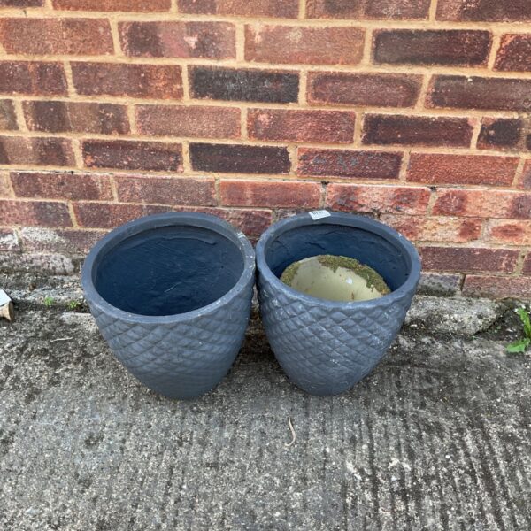 dark gray planters feature a distinct diamond-quilted texture