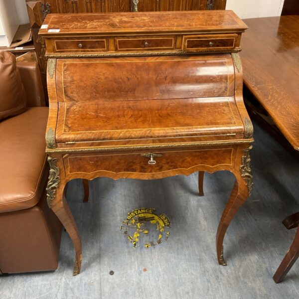Antique Louis XV bureau de dame with ormolu mounts and curved front.