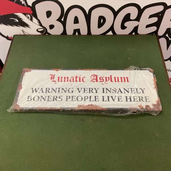 Vintage metal "Lunatic Asylum" sign for wall decoration.