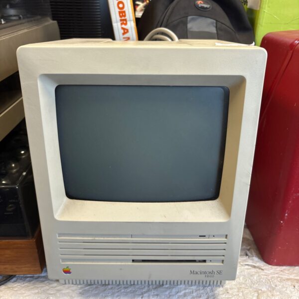 Front view of a vintage Macintosh SE computer with its monitor.