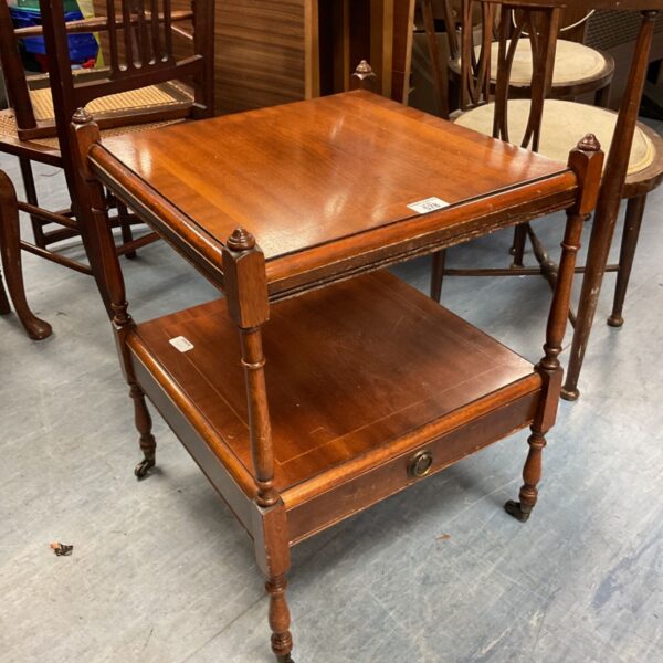 Antique mahogany side table with Georgian style and brass casters.