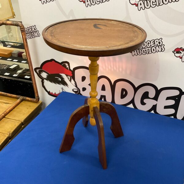 Antique mahogany wine table with tripod legs.