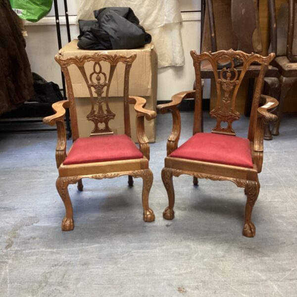 Pair of antique Chippendale armchairs with red velvet upholstery.