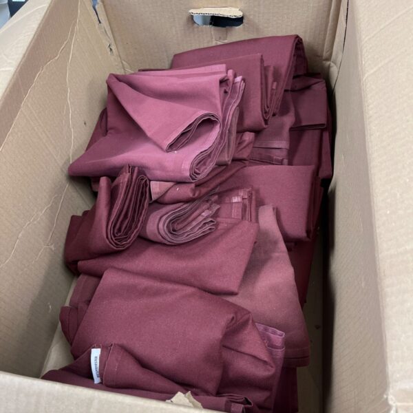 Job lot of maroon napkins presented in a cardboard box.