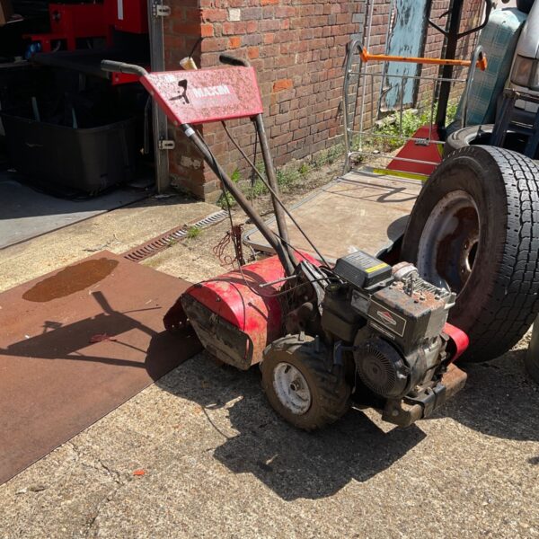 Red Maxim petrol chain drive rotavator for garden use.