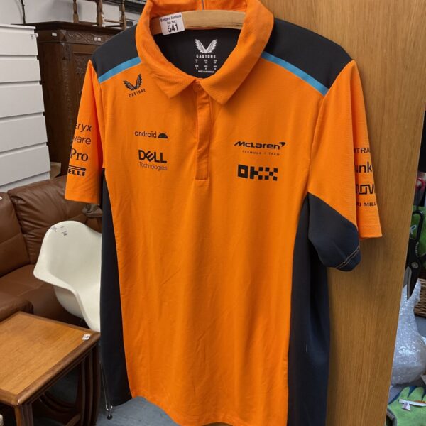 McLaren F1 polo shirt by Castore in papaya orange.