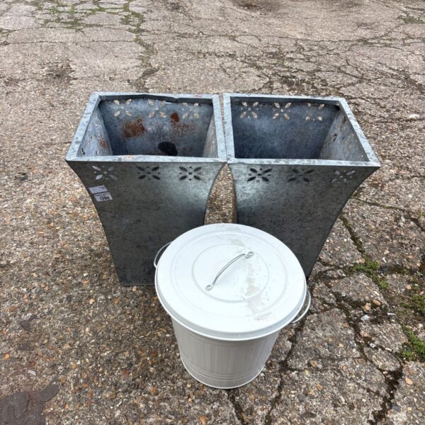 Weathered metal garden planters and bin for rustic outdoor display.