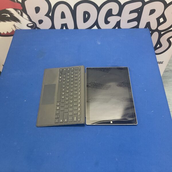 Black Microsoft Surface Pro tablet with attached keyboard.