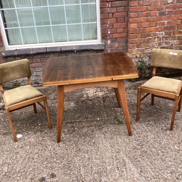 Mid-century modern dining set with table and two chairs.