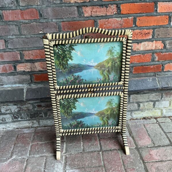 Vintage mid-century fire screen with a peaceful lake scene.