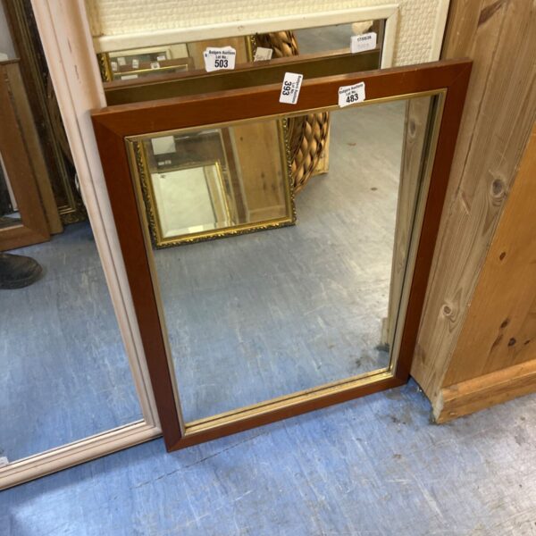 Vintage mid-century mirror with mahogany frame and brass inlay.