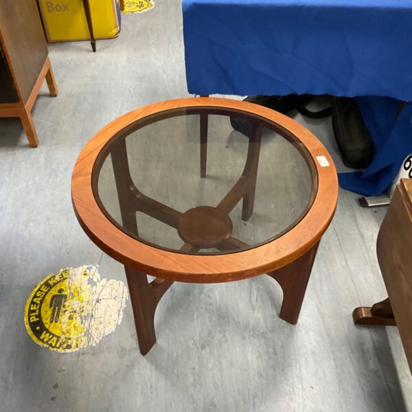 Mid-century coffee table with a smoked glass top and wooden frame.