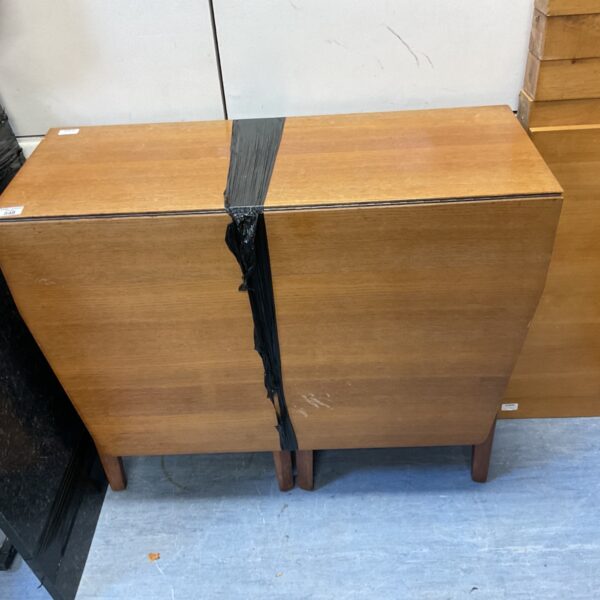 Vintage mid-century modern teak folding table with curved sides.