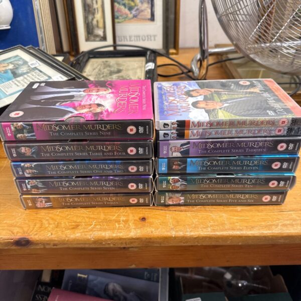 Midsomer Murders DVD collection with various boxed sets and cases.