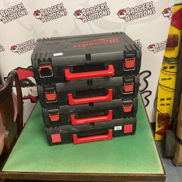 Four Milwaukee stackable tool boxes for tool storage.