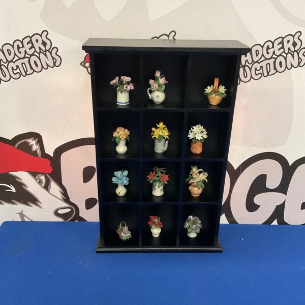 Black lacquer miniature vase display cabinet with nine cubbies.